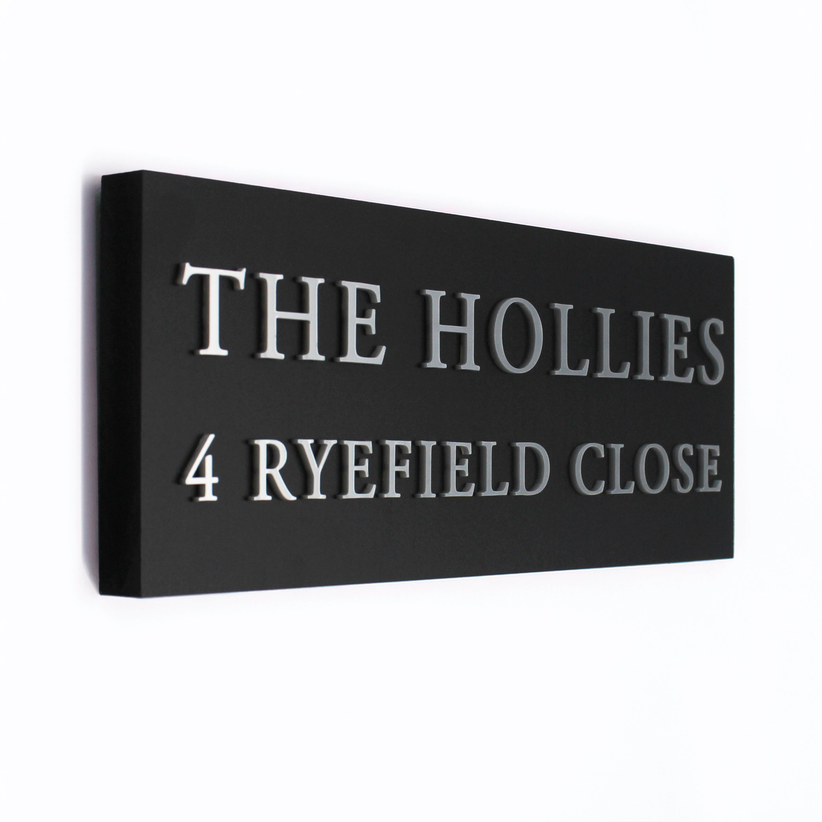Black rectangular sign with silver text this is a side view to show how the raised wording stands out beautifully