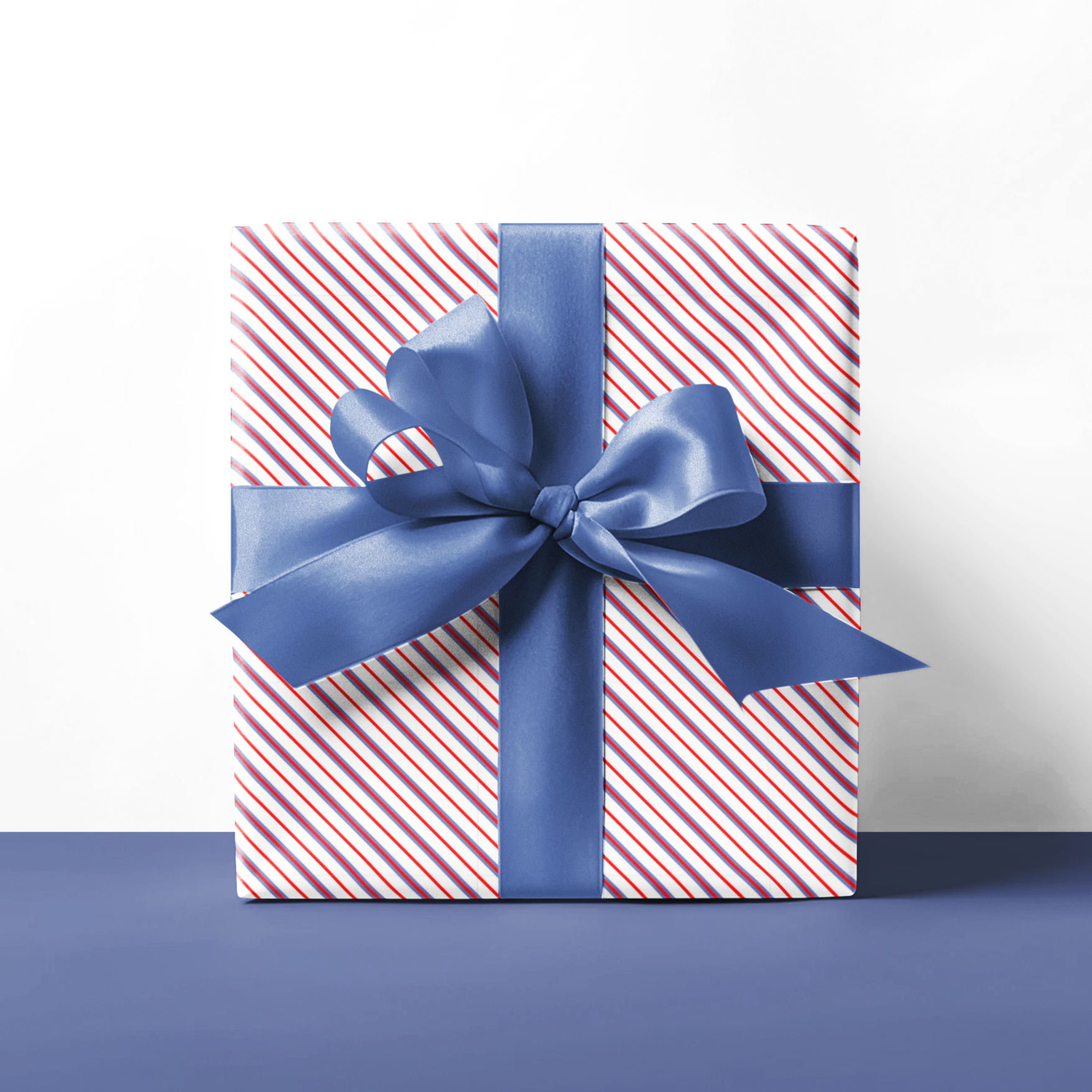 Gift box with red and white stripes and a blue ribbon on a white background