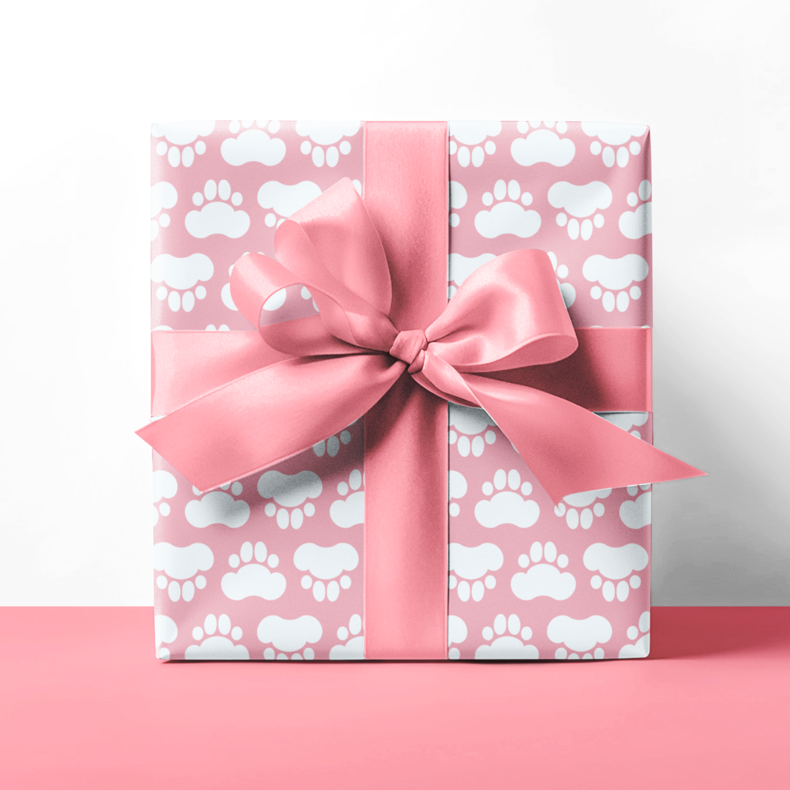 Gift box with paw print pattern and pink bow on a white background