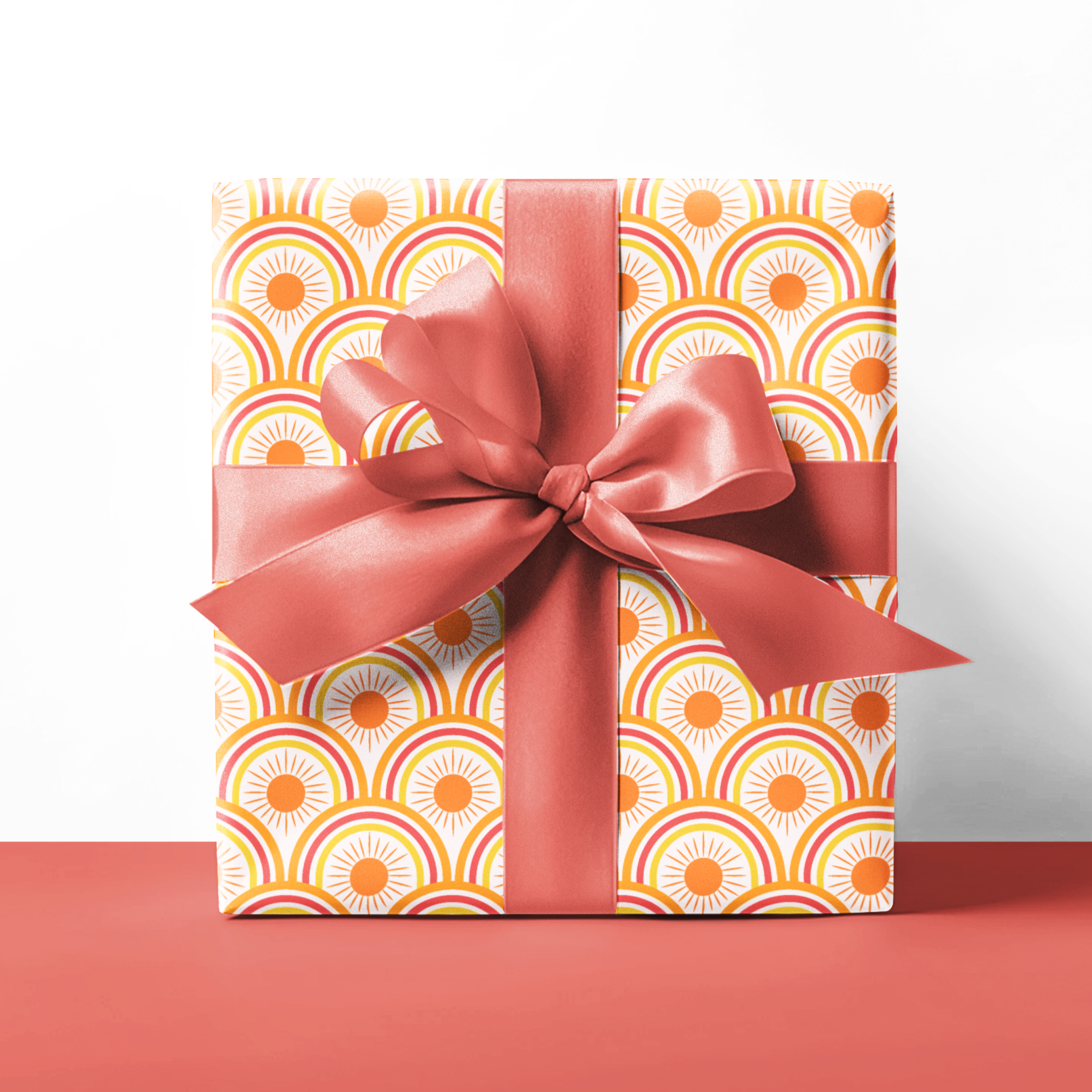 Gift box with a patterned design and a pink ribbon on a white background