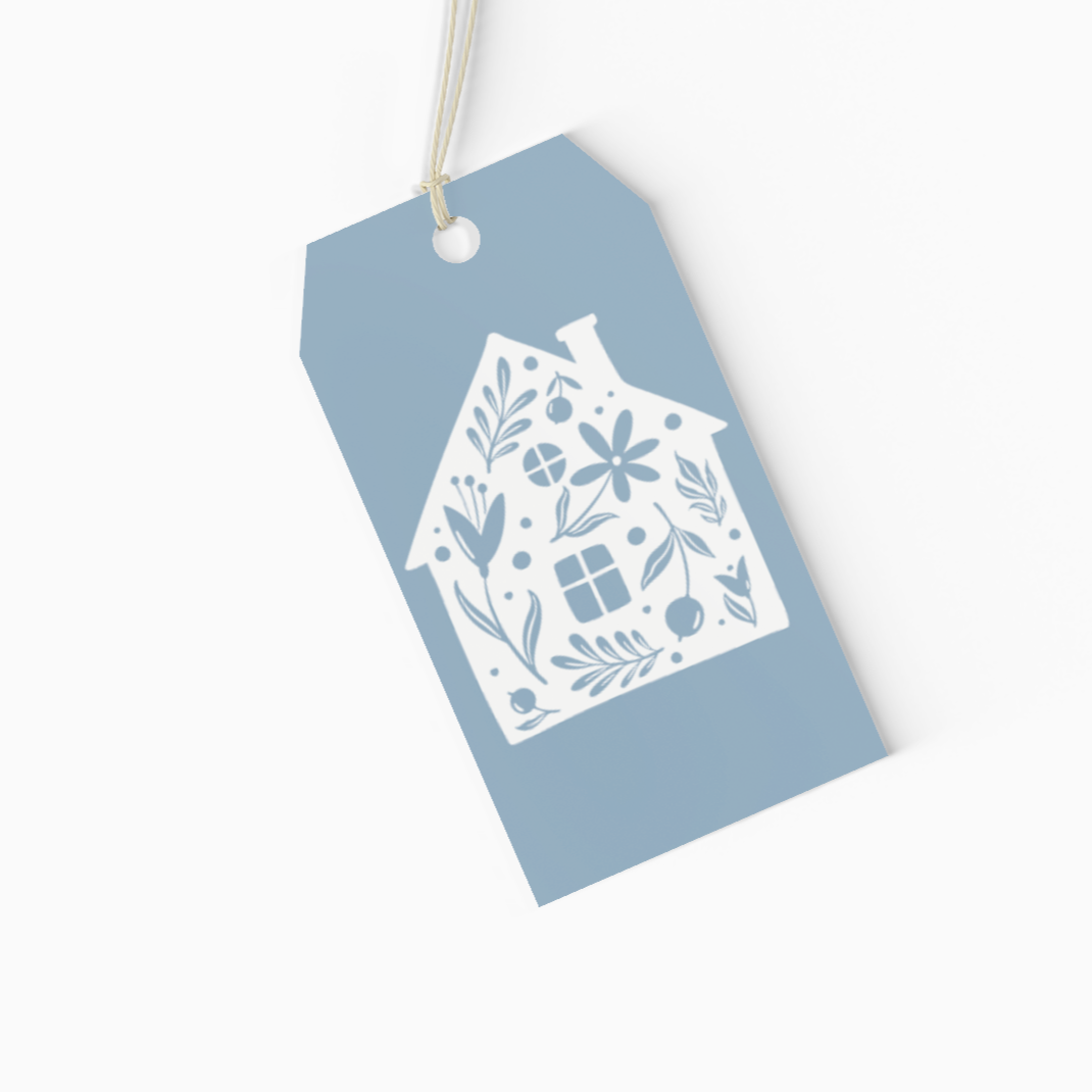 Blue gift tag with white house design on a white background