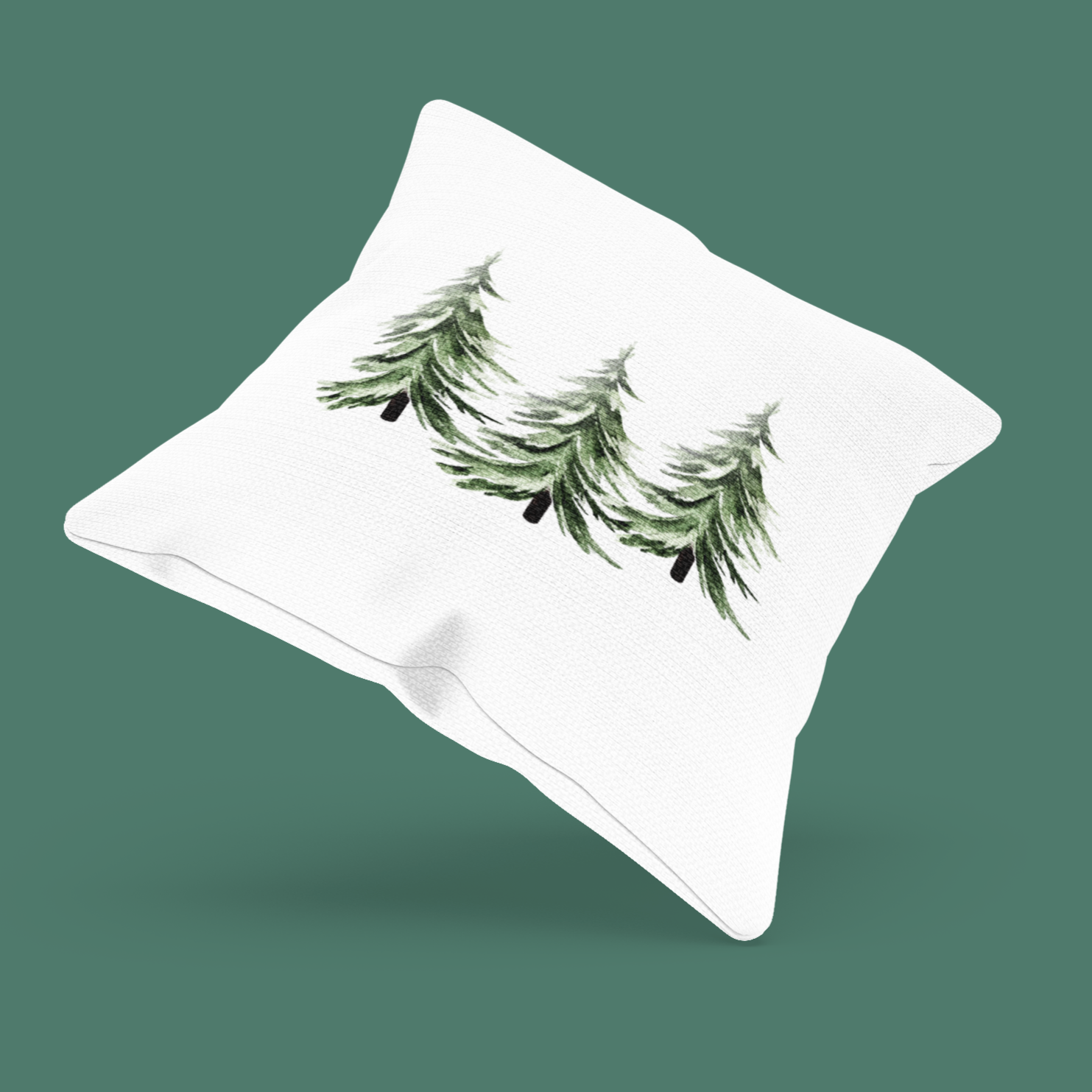 White pillow with green tree's design on a solid background