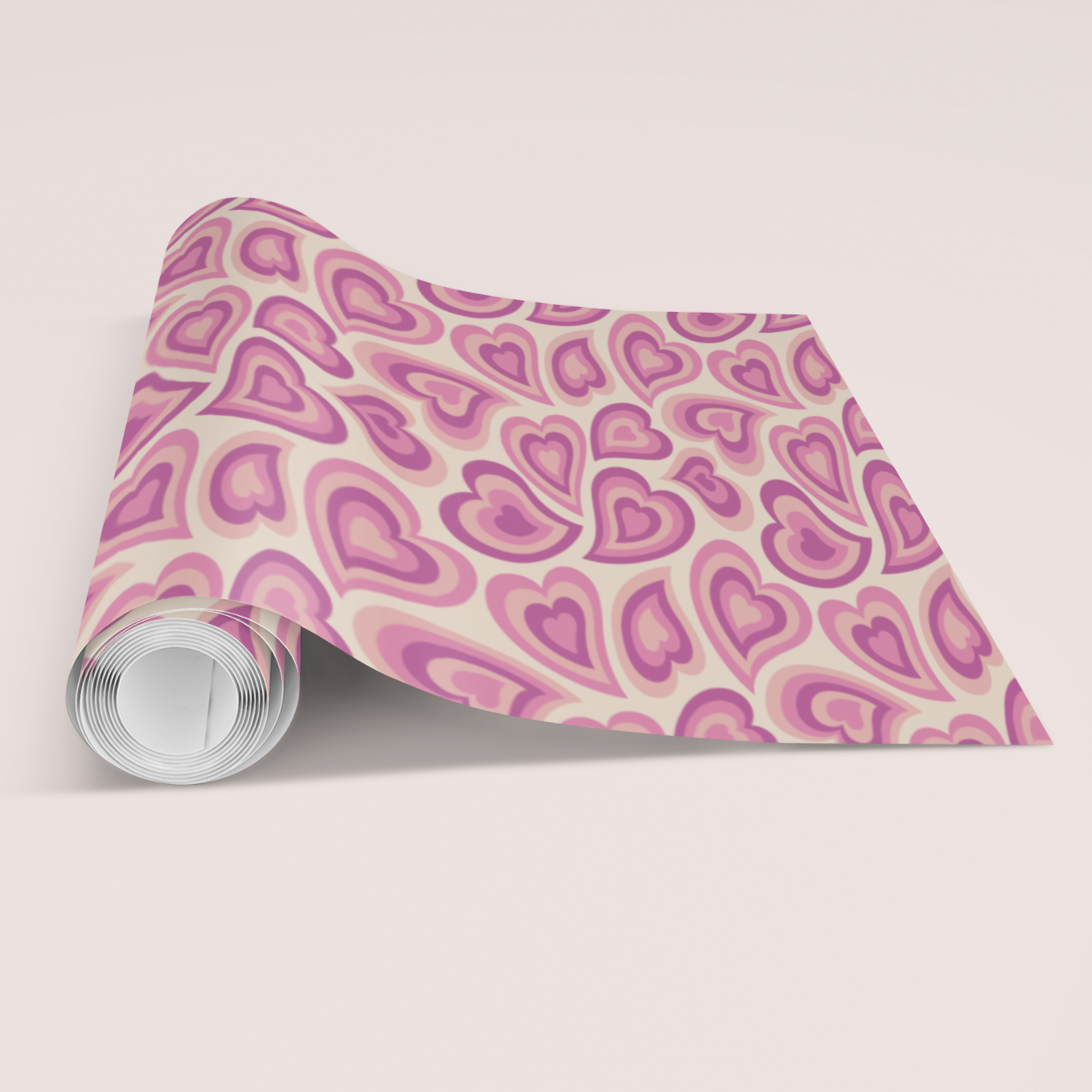 Roll of paper with pink heart pattern on a light gray background