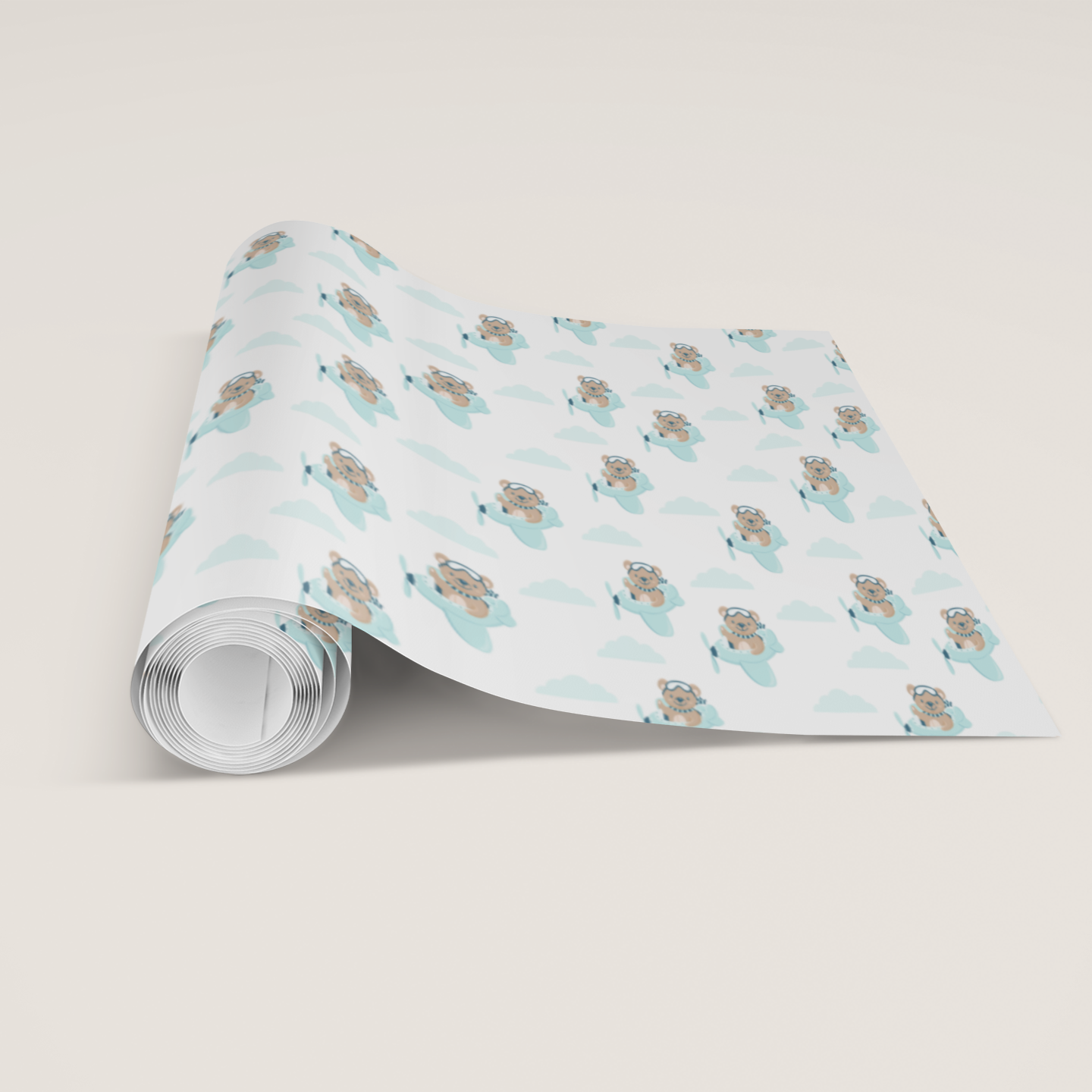 Roll of wrapping paper with teddy bear design on a light gray background