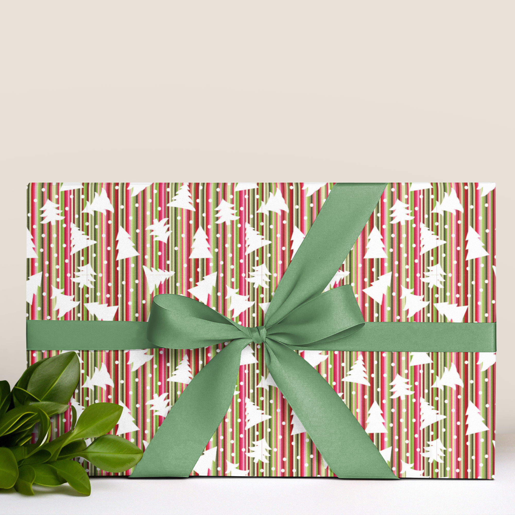 Gift wrap with festive pattern and green ribbon on a white background
