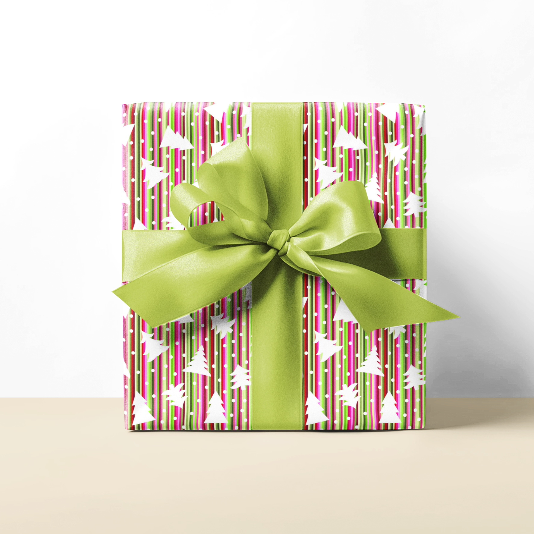 Festive stripe and tress gift wrapping paper with a green ribbon on a white background