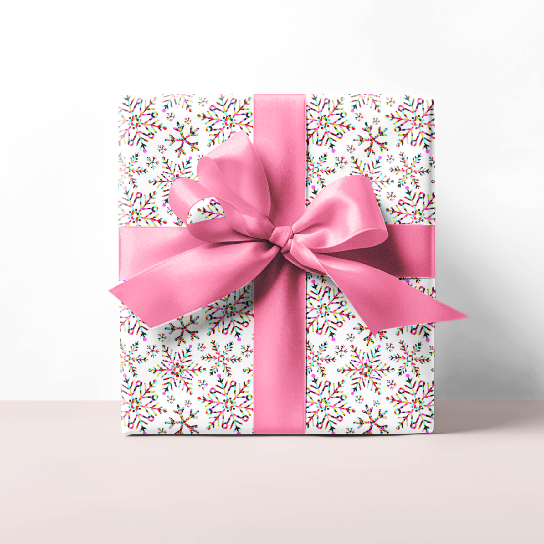 Christmas Gift wrap for girls with snow flake funky pattern and pink bow on a white background