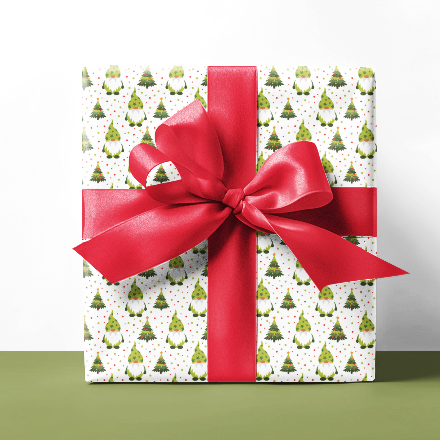 Gift wrap with Christmas gnomes pattern and red ribbon on a white background
