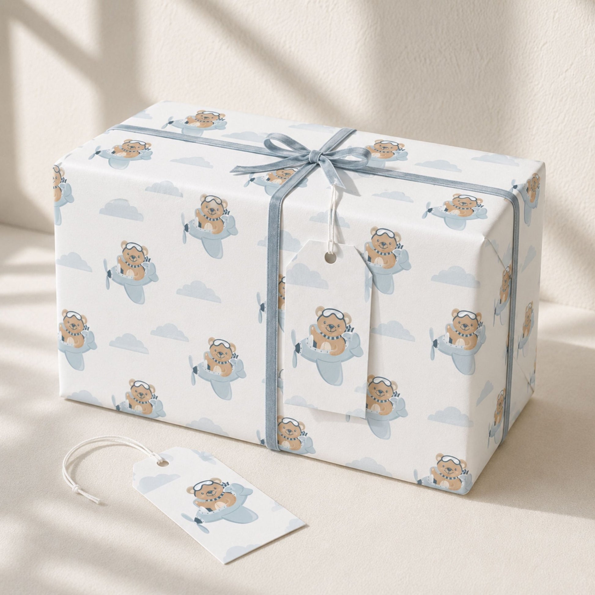 Gift wrapped in Teddy Bear Aeroplane wrapping paper with blue ribbon