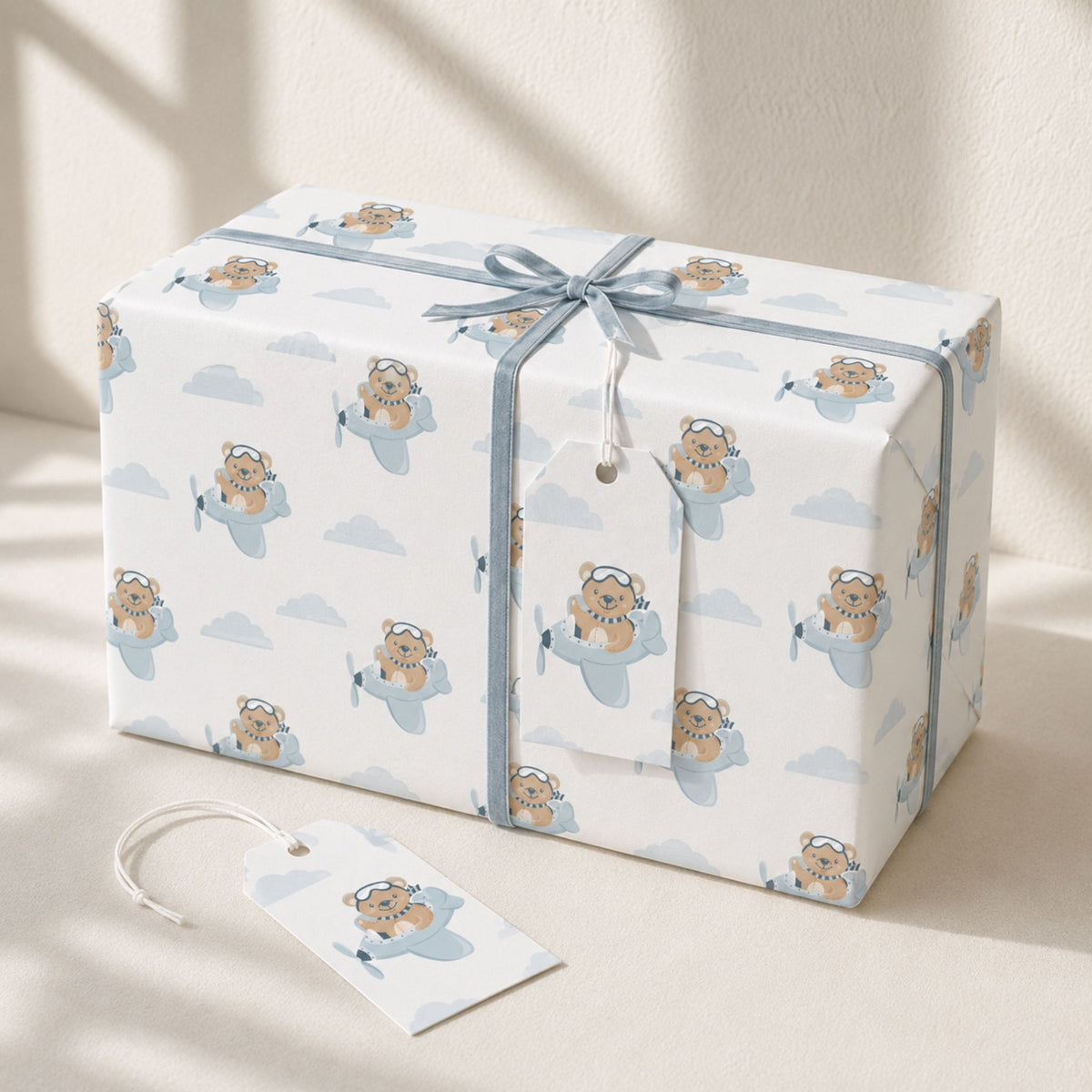 Gift wrapped in Teddy Bear Aeroplane wrapping paper with blue ribbon